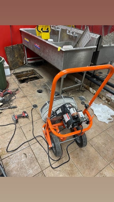 Commercial drain cleaning with a powered auger