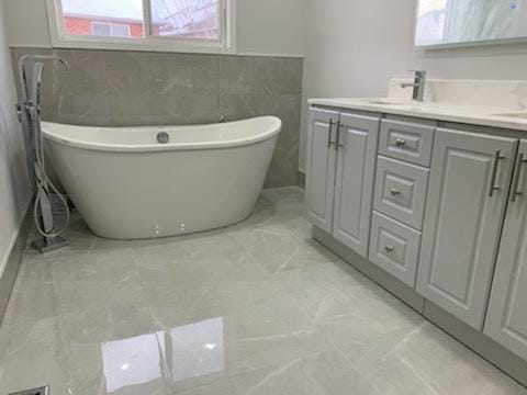 Finished bathroom with freestanding tub and double vanity