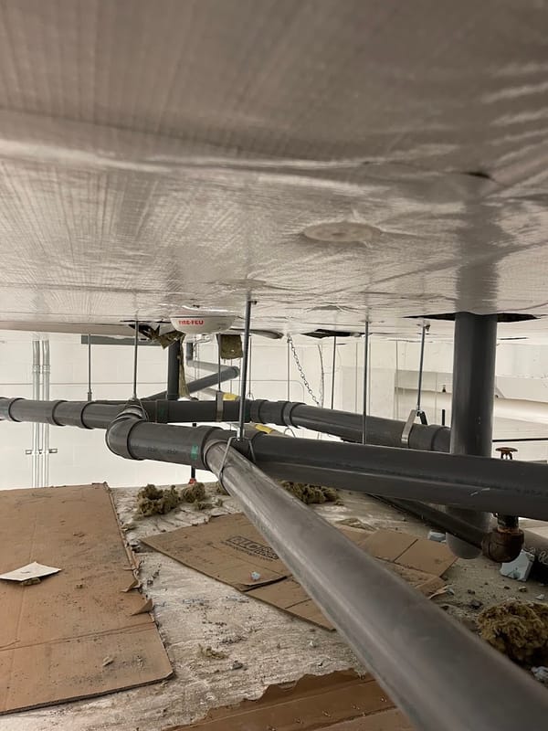 Suspended drain lines in a commercial ceiling